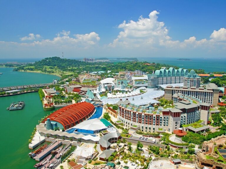 Aerial view of Sentosa Island in Singapore showcasing luxury resorts, attractions, and waterfront scenery.