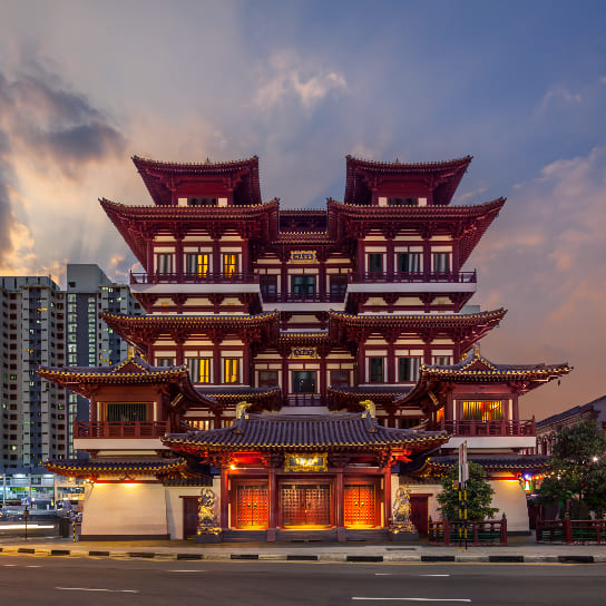 Buddha Tooth Relic Temple and Museum in Chinatown, Singapore, illuminated at dusk.